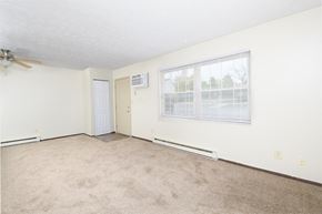 Miamisburg apartment for rent - an empty living room with a window and a door