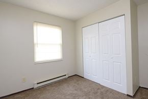 Miamisburg apartment for rent - an empty bedroom with two doors and a window