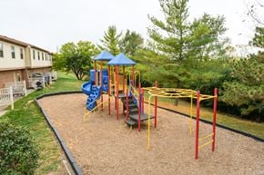 Miamisburg apartment for rent - a playground in a yard with a blue and yellow swing set