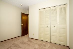 Dayton apartment for rent - a bedroom with two closets and a door to a hallway