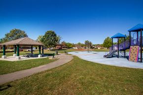 Dayton apartment for rent - a playground with a pavilion and slides in a park