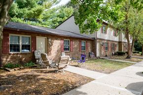 Urbana apartment for rent - a brick house with two rocking chairs in front of it