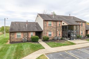Moraine apartment for rent - the front of a brick house with a glass walkway and grass