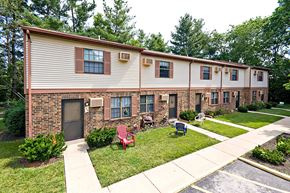 West Alexandria apartment for rent - an apartment building with lawn chairs and a sidewalk