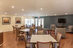 Peoria apartment for rent - a dining room with tables and chairs and a television