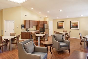 Peoria apartment for rent - a living room with chairs and tables and a kitchen