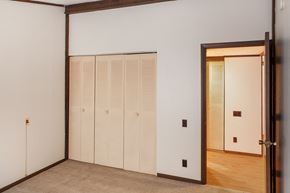 Mitchell apartment for rent - a bedroom with white walls and a door to a closet