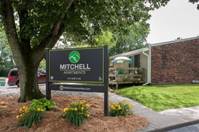 Mitchell apartment for rent - a sign apartments in front of a tree