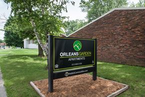 Orleans apartment for rent - a sign apartments in front of a brick building