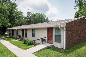 Orleans apartment for rent - a small white house with a porch and a sidewalk