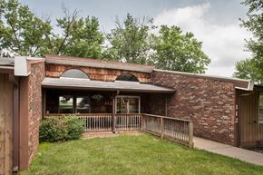 Paoli apartment for rent - the front of a brick building with a porch and a lawn