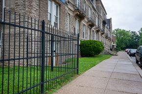 Cincinnati apartment for rent - a black wrought iron fence in front of a church