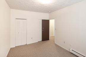 Cincinnati apartment for rent - a bedroom with white walls and a closet and a door
