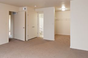 Cincinnati apartment for rent - an empty living room with an open door to a bathroom