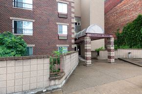 Cincinnati apartment for rent - the outside of a brick building with a sidewalk