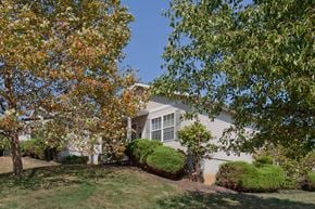 Cincinnati apartment for rent - a white house with a lawn and trees in front of it