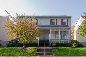 Cincinnati apartment for rent - a white house with a porch and a tree in front of it