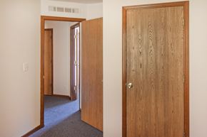 Cincinnati apartment for rent - an open bedroom door and a hallway with a door to a bedroom and a closet