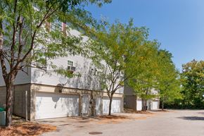 Cincinnati apartment for rent - a white building with white garage doors and trees