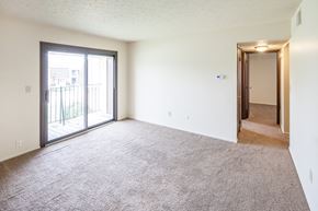 Mt. Orab apartment for rent - an empty living room with a sliding glass door to a balcony