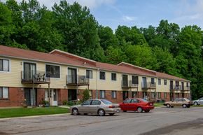 Georgetown apartment for rent - a row of apartment buildings with cars parked in front