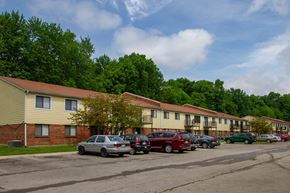 Georgetown apartment for rent - a row of apartment buildings with cars parked in a parking lot