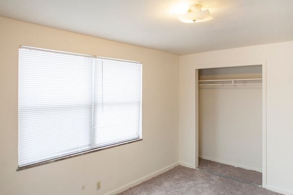Cincinnati apartment for rent - a bedroom with a large window and a closet