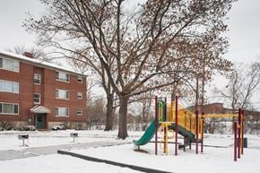 Cincinnati apartment for rent - a playground in the snow in front of a building