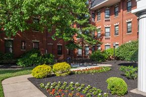 Cincinnati apartment for rent - a courtyard with a picnic table in front of a brick building