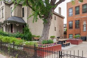 Covington apartment for rent - a courtyard with a tree and a picnic table in front of a building
