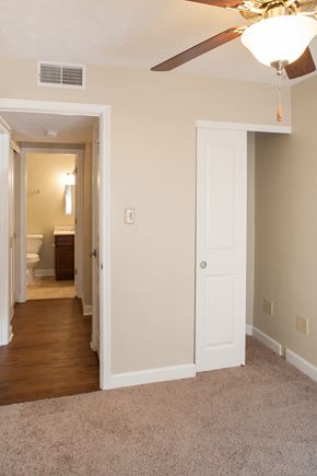 Dry Ridge apartment for rent - a bedroom with a ceiling fan and a hallway to a bathroom