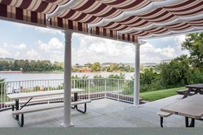 Ludlow apartment for rent - a red and white striped awning over a patio with benches