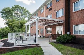 Ludlow apartment for rent - a patio with a white canopy in front of a brick building
