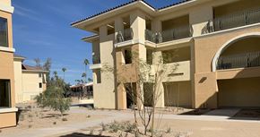 Phoenix apartment for rent - a building with two balconies and a sidewalk in front of it