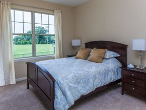 Maplewood apartment for rent - a bedroom with a bed and a large window