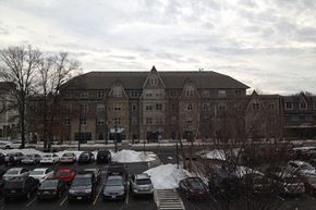 Fanwood apartment for rent - a parking lot full of cars in front of a large building