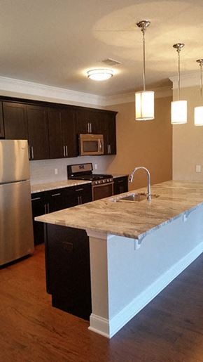 Fanwood apartment for rent - a kitchen with an island and a stainless steel refrigerator