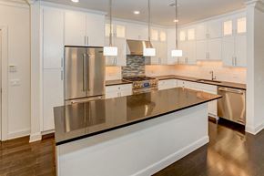 Bernardsville apartment for rent - a kitchen with white cabinets and stainless steel appliances