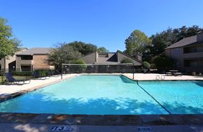 Arlington apartment for rent - the view of a swimming pool with an apartment building in the background