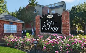 Houston apartment for rent - a sign in front of a building with pink flowers