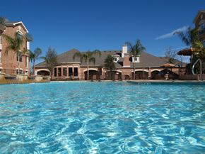 Houston apartment for rent - the view of a swimming pool with a large building in the background
