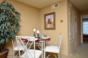 Houston apartment for rent - a dining area with a table and chairs and a plant