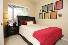 Dallas apartment for rent - a bedroom with a bed and some pictures on the wall