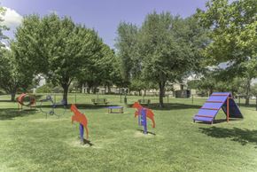 Plano apartment for rent - A playground with a slide, swings, and a seesaw.
