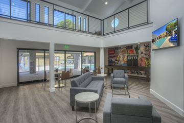 Phoenix apartment for rent - A living room with grey couches and a television on the wall.