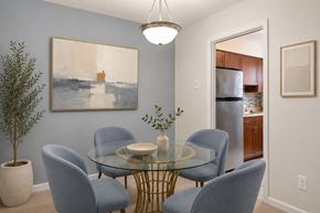 Alexandria apartment for rent - A dining room with a glass table and blue chairs.