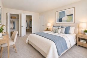 Fairfax apartment for rent - A bedroom with a large bed and a chair.
