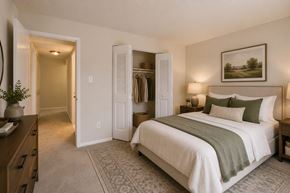 Fairfax apartment for rent - A bedroom with a large bed and a painting on the wall.