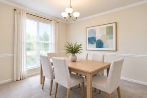 Fairfax apartment for rent - A dining room with a wooden table and chairs.