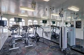 Fairfax apartment for rent - a gym with cardio equipment and windows